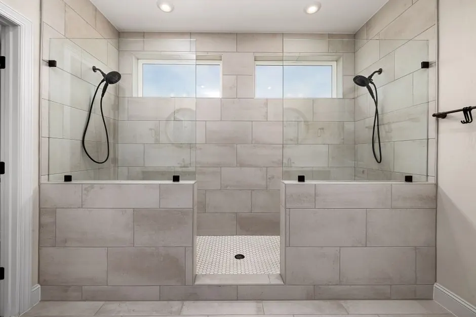 A sleek, contemporary dual shower bathroom featuring elegant tile work and modern fixtures.